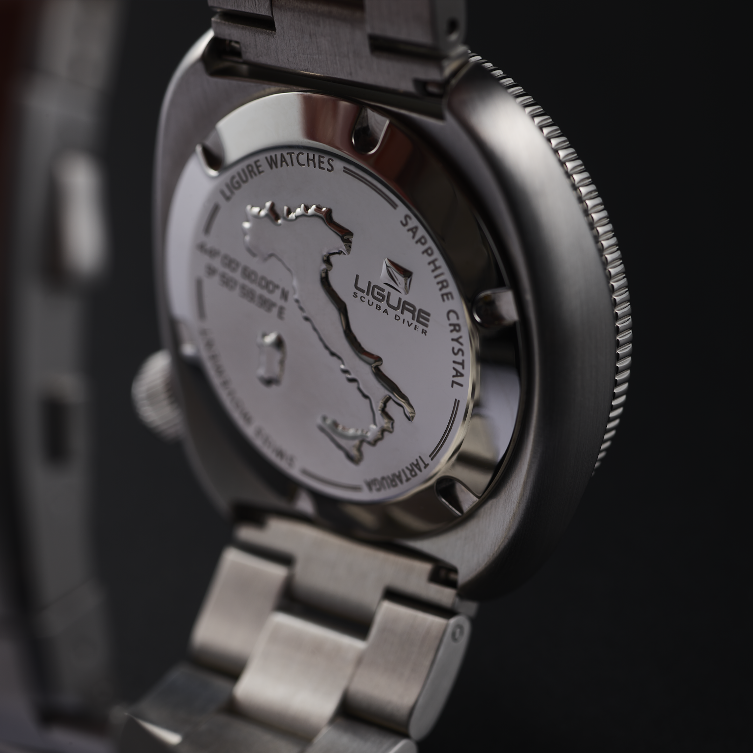 Close-up of a LWT21008_Founders_Edition_GMT silver watch with engraved details on a dark background
